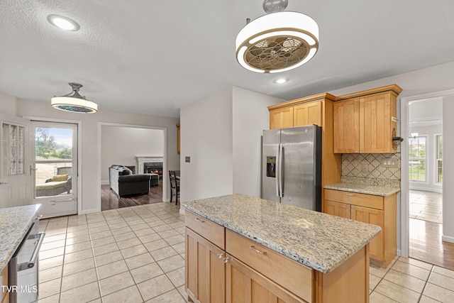 945 Dashaway Rd, Chuckey, TN 37641 - kitchen featuring stainless steel fridge with ice dispenser, tasteful backsplash, light tile patterned flooring, healthy amount of natural light, and recessed lighting