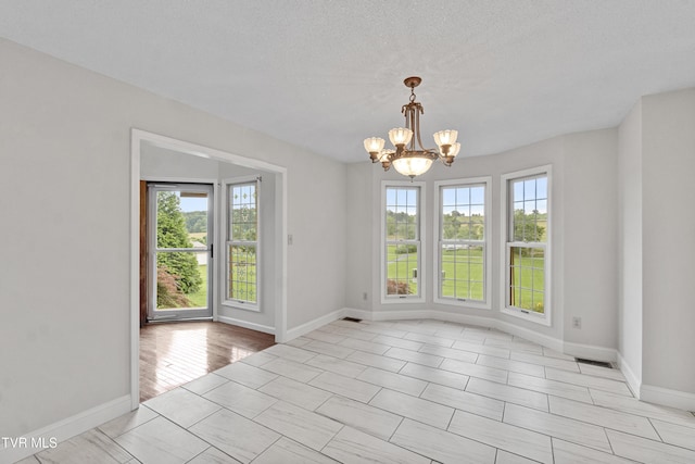 945 Dashaway Rd, Chuckey, TN 37641 - empty room with a chandelier and a textured ceiling