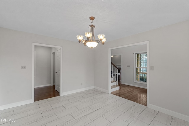 945 Dashaway Rd, Chuckey, TN 37641 - spare room featuring a chandelier and stairs
