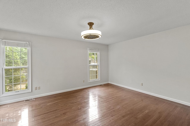 945 Dashaway Rd, Chuckey, TN 37641 - empty room with wood finished floors and a textured ceiling