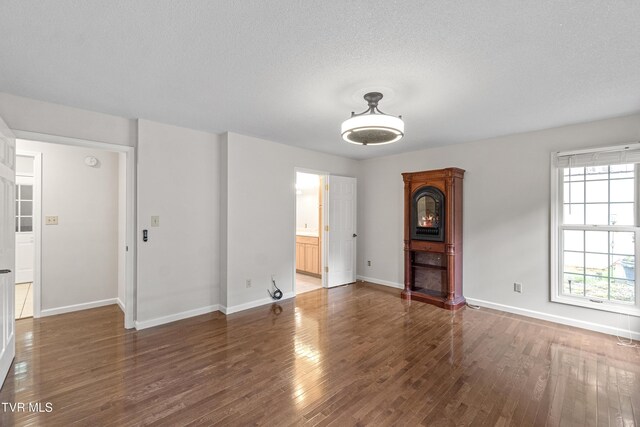 945 Dashaway Rd, Chuckey, TN 37641 - unfurnished living room with wood finished floors and a textured ceiling