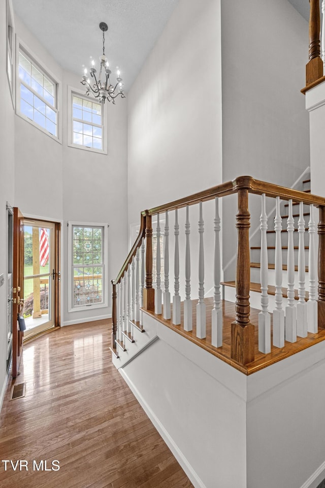 945 Dashaway Rd, Chuckey, TN 37641 - stairs with a high ceiling, wood finished floors, and a chandelier