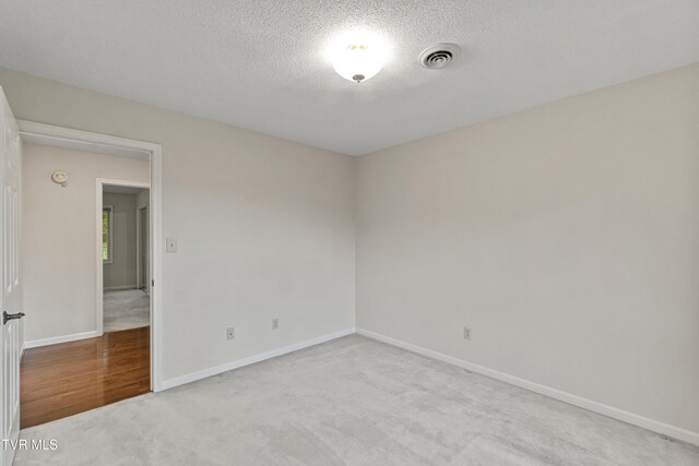 945 Dashaway Rd, Chuckey, TN 37641 - unfurnished room featuring light carpet and a textured ceiling