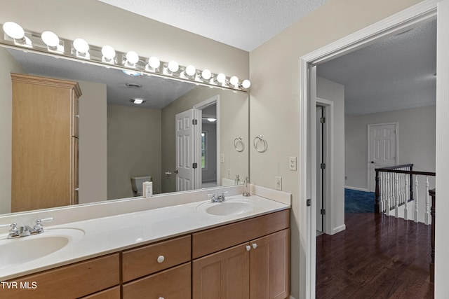 945 Dashaway Rd, Chuckey, TN 37641 - full bathroom with double vanity, wood finished floors, and a textured ceiling
