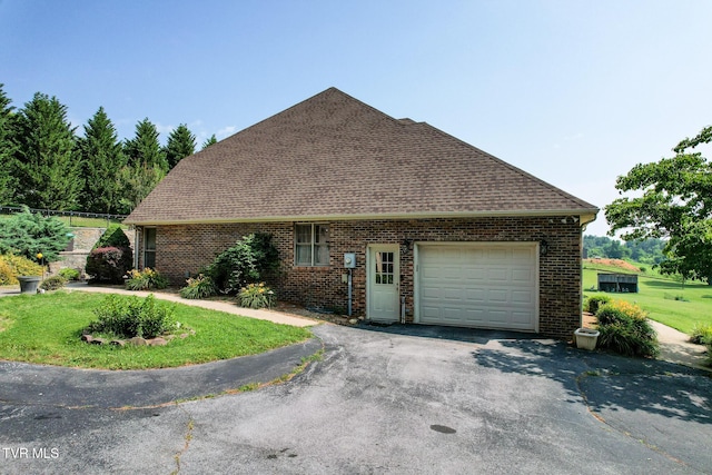 945 Dashaway Rd, Chuckey, TN 37641 - view of side of property featuring a garage, driveway, brick siding, a shingled roof, and a yard