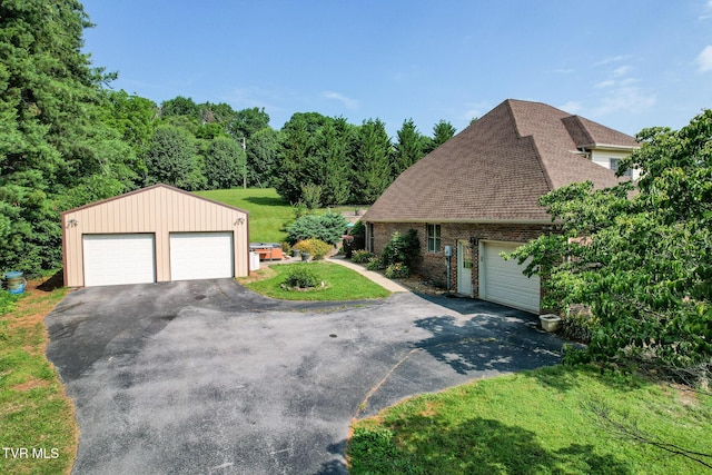 945 Dashaway Rd, Chuckey, TN 37641 - view of front of home with brick siding, a shingled roof, a detached garage, an outdoor structure, and a front lawn