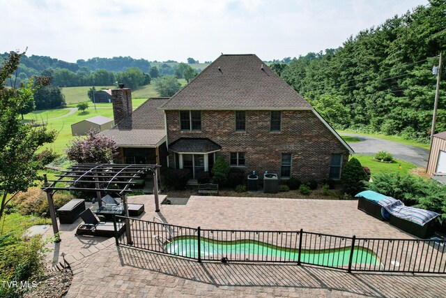 945 Dashaway Rd, Chuckey, TN 37641 - back of house with a patio, a chimney, brick siding, and a shingled roof