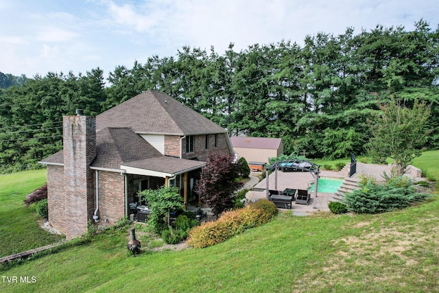 945 Dashaway Rd, Chuckey, TN 37641 - rear view of house featuring a patio area, a lawn, a chimney, roof with shingles, and an outdoor pool