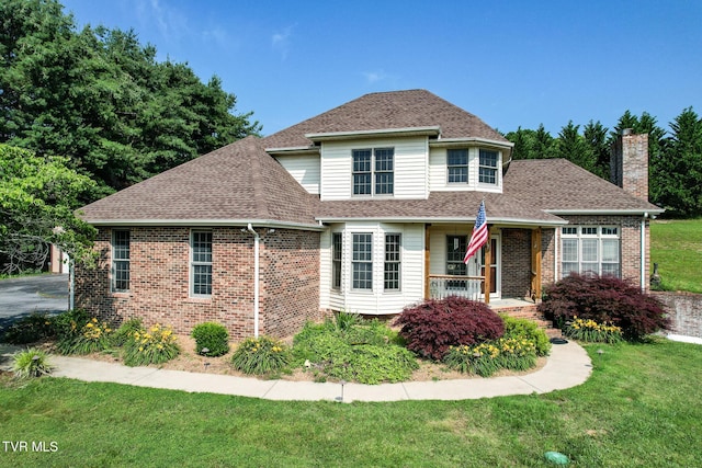 945 Dashaway Rd, Chuckey, TN 37641 - view of front of house featuring a porch, a chimney, a front yard, and a shingled roof