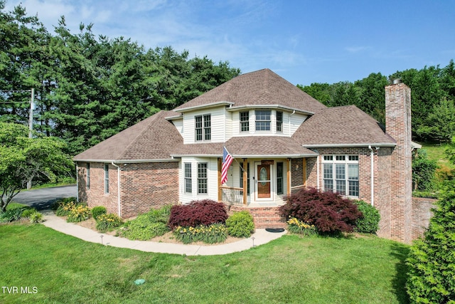 945 Dashaway Rd, Chuckey, TN 37641 - view of front of house featuring brick siding, a chimney, a front lawn, and roof with shingles