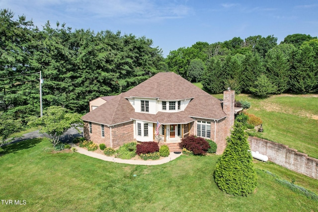 945 Dashaway Rd, Chuckey, TN 37641 - view of front facade with brick siding, a front lawn, a chimney, roof with shingles, and a wooded view