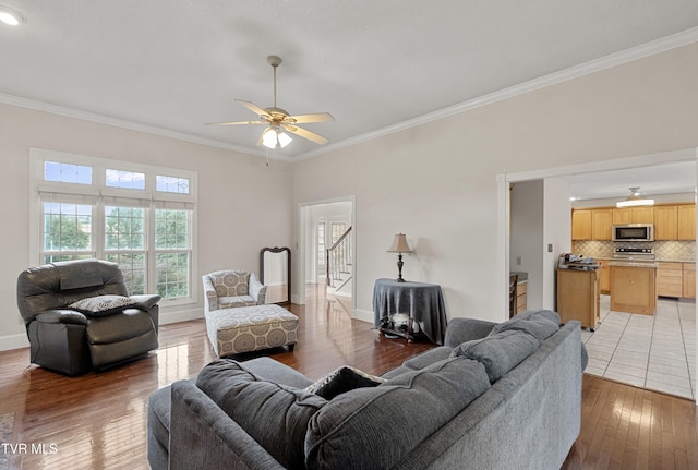 945 Dashaway Rd, Chuckey, TN 37641 - living room with crown molding, ceiling fan, light wood-type flooring, and stairs