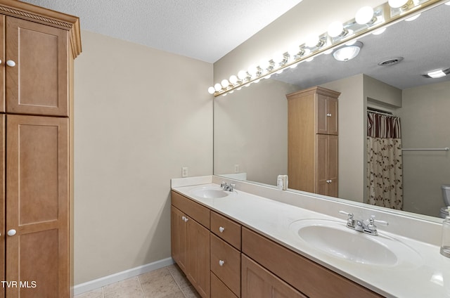 945 Dashaway Rd, Chuckey, TN 37641 - bathroom featuring double vanity, a textured ceiling, and tile patterned floors