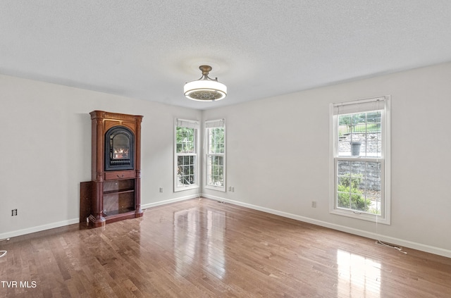 945 Dashaway Rd, Chuckey, TN 37641 - unfurnished living room with wood finished floors and a textured ceiling