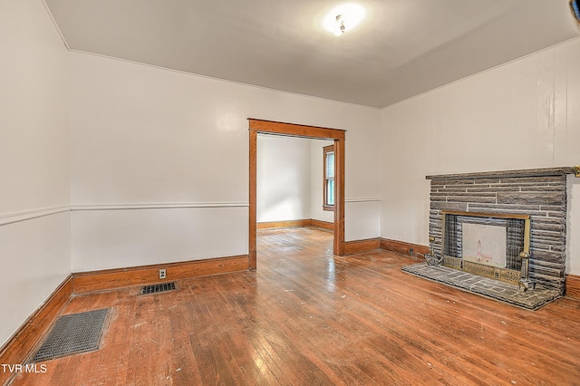 1149 Moorland Ave, Bristol, VA 24201 - unfurnished living room with hardwood / wood-style flooring and a stone fireplace