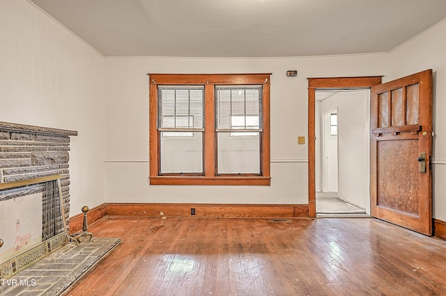 1149 Moorland Ave, Bristol, VA 24201 - unfurnished living room featuring a fireplace with raised hearth and hardwood / wood-style flooring