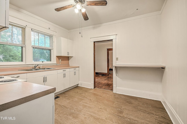 1149 Moorland Ave, Bristol, VA 24201 - kitchen with white cabinets, a ceiling fan, light wood-type flooring, light countertops, and ornamental molding