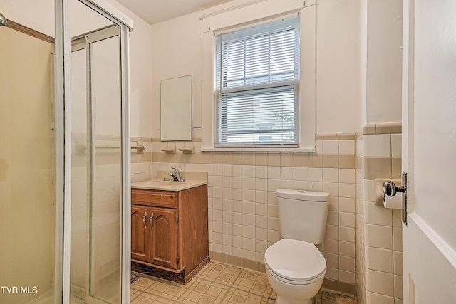 1149 Moorland Ave, Bristol, VA 24201 - full bathroom with vanity, a stall shower, a wainscoted wall, tile walls, and tile patterned floors