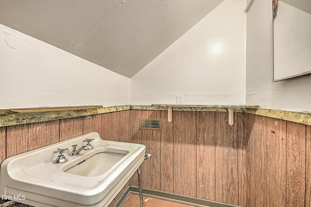 1149 Moorland Ave, Bristol, VA 24201 - bathroom featuring vaulted ceiling, a wainscoted wall, and wooden walls