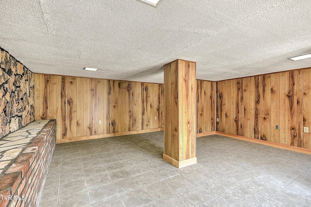 307 Tween Hills Rd, Bristol, TN 37620 - finished basement with a textured ceiling, wood walls, and light tile patterned floors
