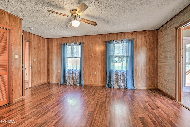 307 Tween Hills Rd, Bristol, TN 37620 - unfurnished room with ceiling fan, wood finished floors, wooden walls, and a textured ceiling
