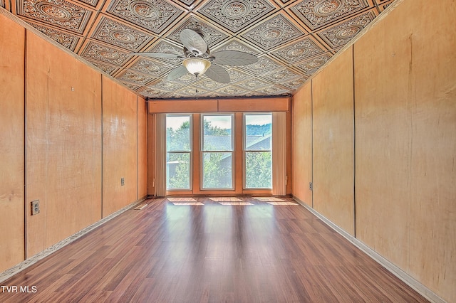 307 Tween Hills Rd, Bristol, TN 37620 - empty room with an ornate ceiling, wood finished floors, ceiling fan, and wood walls