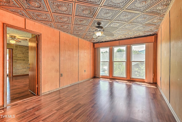 307 Tween Hills Rd, Bristol, TN 37620 - empty room with ceiling fan, an ornate ceiling, wood finished floors, and wooden walls