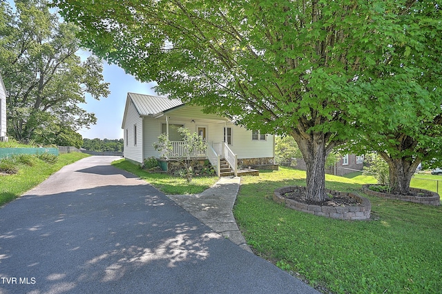 307 Tween Hills Rd, Bristol, TN 37620 - view of front of house featuring a front yard, driveway, a porch, and a metal roof