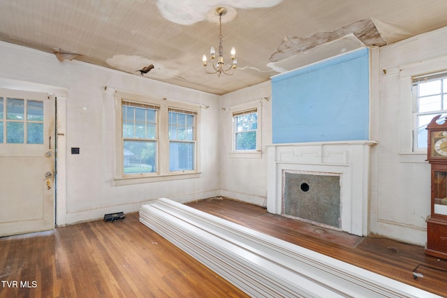 1411 E Unaka Ave, Johnson City, TN 37601 - unfurnished living room with wood finished floors, plenty of natural light, a chandelier, and a fireplace with flush hearth