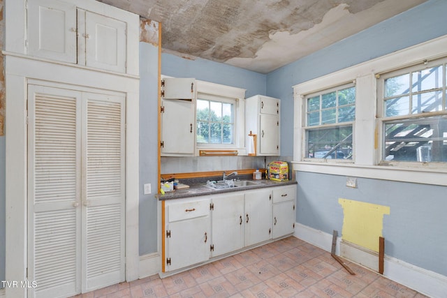 1411 E Unaka Ave, Johnson City, TN 37601 - kitchen with white cabinetry, dark countertops, and brick patterned flooring