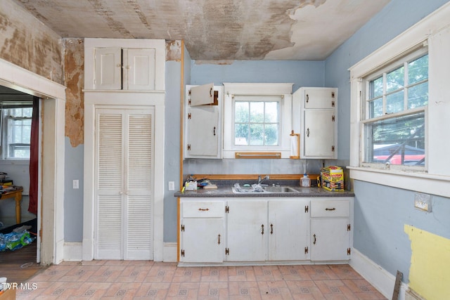 1411 E Unaka Ave, Johnson City, TN 37601 - kitchen with healthy amount of natural light, white cabinets, and brick patterned flooring