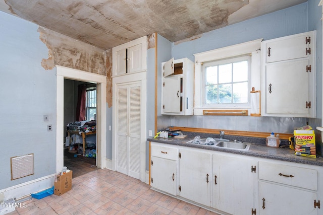 1411 E Unaka Ave, Johnson City, TN 37601 - kitchen with dark countertops and white cabinetry