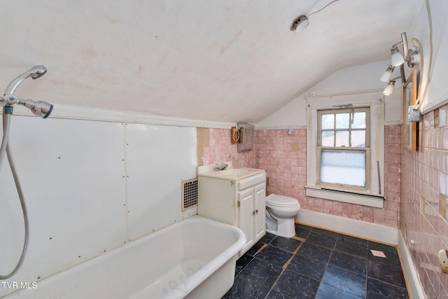 1411 E Unaka Ave, Johnson City, TN 37601 - bathroom featuring lofted ceiling, tile walls, and a bathtub