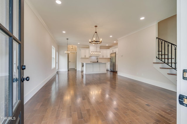 2009 Idle Hour Rd, Kingsport, TN 37660 - unfurnished living room featuring ornamental molding, a chandelier, stairs, dark wood-type flooring, and recessed lighting