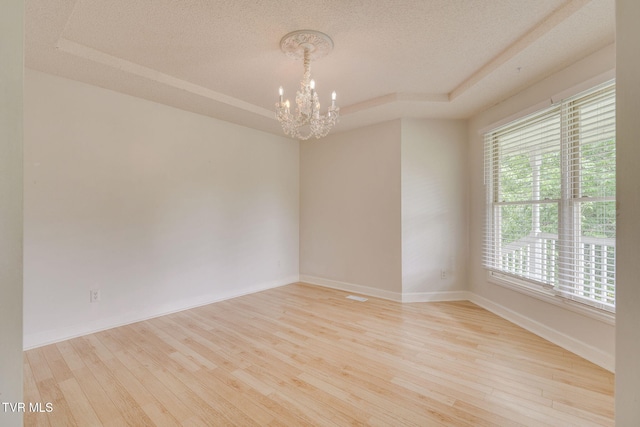 256 S Creek Ct, Kingsport, TN 37663 - spare room featuring a tray ceiling, a chandelier, wood finished floors, and a textured ceiling