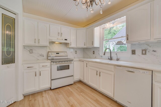 256 S Creek Ct, Kingsport, TN 37663 - kitchen with white appliances, under cabinet range hood, a chandelier, white cabinetry, and backsplash