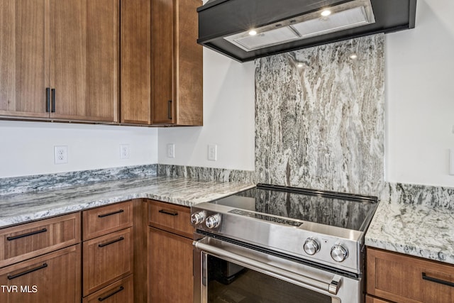 1533 Pactolas Rd Unit 107, Johnson City, TN 37604 - kitchen with electric range, exhaust hood, light stone counters, and brown cabinetry