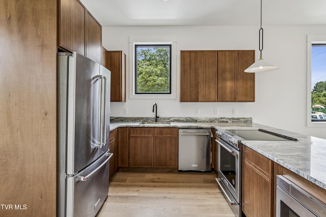 1533 Pactolas Rd Unit 107, Johnson City, TN 37604 - kitchen featuring stainless steel appliances, light wood-type flooring, plenty of natural light, and light stone counters