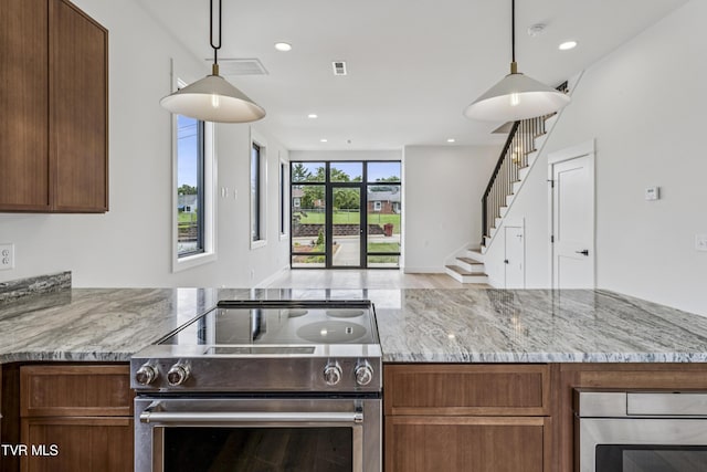 1533 Pactolas Rd Unit 107, Johnson City, TN 37604 - kitchen with stainless steel appliances, light stone countertops, open floor plan, hanging light fixtures, and recessed lighting
