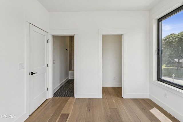 1533 Pactolas Rd Unit 107, Johnson City, TN 37604 - unfurnished bedroom featuring light wood finished floors and baseboards