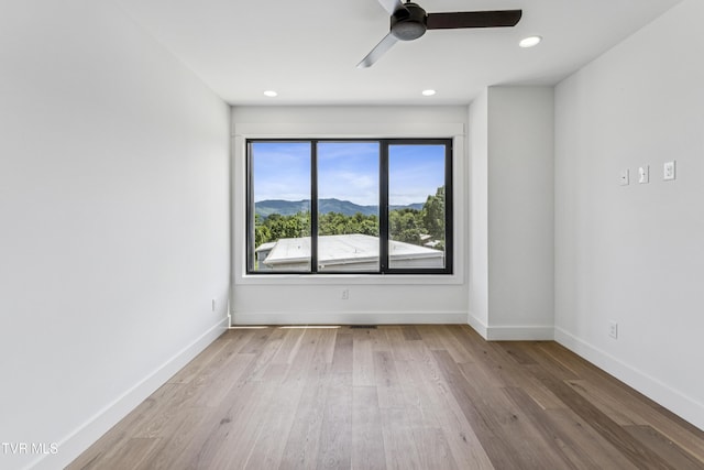 1533 Pactolas Rd Unit 107, Johnson City, TN 37604 - unfurnished room featuring a ceiling fan, wood finished floors, a mountain view, and recessed lighting