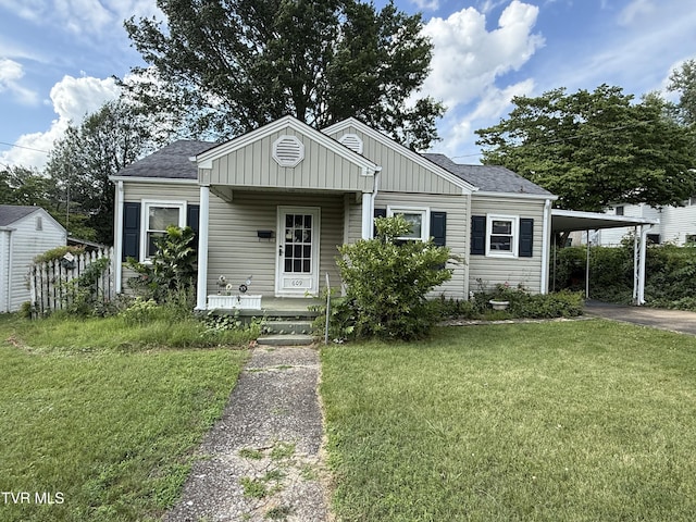 609 W D St, Elizabethton, TN 37643 - bungalow-style house featuring a front lawn, an attached carport, asphalt driveway, and a shingled roof