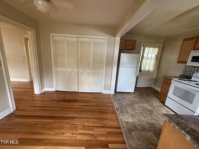 609 W D St, Elizabethton, TN 37643 - kitchen with white appliances, a ceiling fan, dark countertops, and wood finished floors