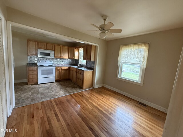 609 W D St, Elizabethton, TN 37643 - kitchen featuring white appliances, hardwood / wood-style flooring, tasteful backsplash, and ceiling fan