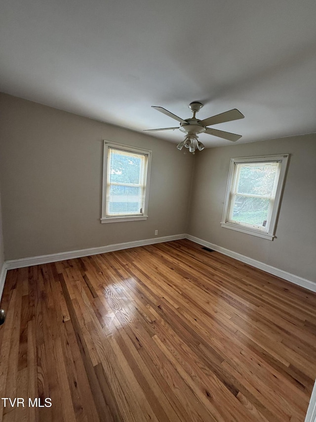 609 W D St, Elizabethton, TN 37643 - spare room featuring plenty of natural light, a ceiling fan, and wood finished floors