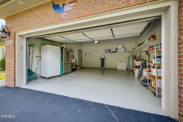 1645 Old Stagecoach Rd, Jonesborough, TN 37659 - garage with electric water heater, freestanding refrigerator, and driveway