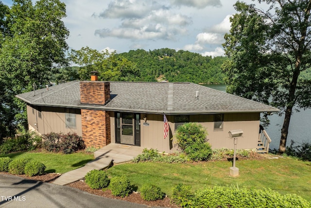 22627 Montego Bay Rd, Abingdon, VA 24211 - single story home with a shingled roof, a chimney, and a front lawn