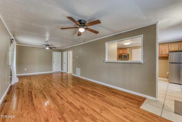 2642 Broad St, Bristol, TN 37620 - unfurnished living room featuring ceiling fan and light wood-style floors