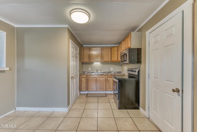 2642 Broad St, Bristol, TN 37620 - kitchen featuring stainless steel appliances, light tile patterned floors, crown molding, and brown cabinets