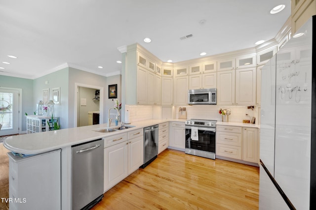 788 Watauga Rd, Watauga, TN 37694 - kitchen with appliances with stainless steel finishes, a peninsula, crown molding, tasteful backsplash, and light countertops
